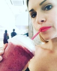 Close-up portrait of young woman holding ice cream