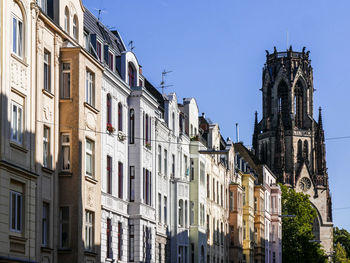 Low angle view of buildings against blue sky