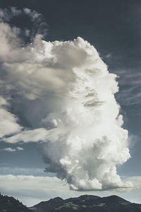 Low angle view of volcanic mountain against sky