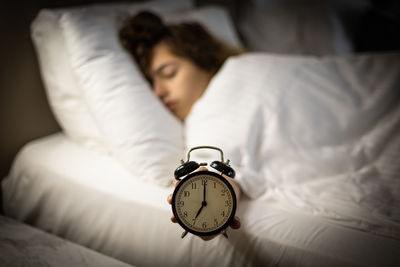 Young woman sleeping on bed at home