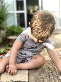 Cute boy sitting outdoors