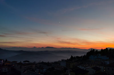 High angle view of townscape against sky at sunset