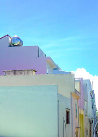 Low angle view of buildings against blue sky