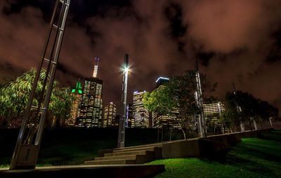 Low angle view of illuminated buildings against sky at night