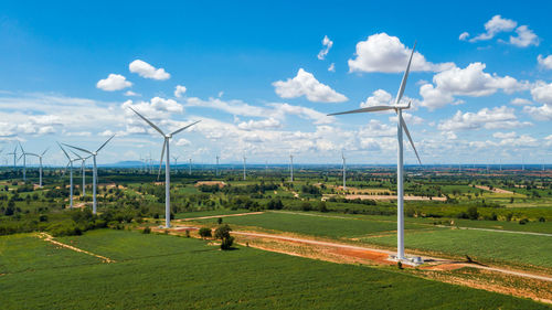 Aerial landscape of windmills farm with white sky on blue sky at huai bong, dan khun thot district, 