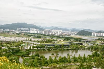 Scenic view of lake by buildings against sky