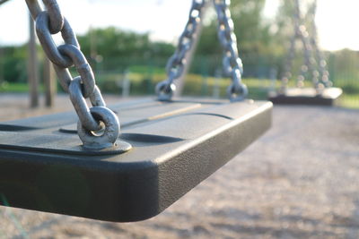 Close-up of chain swing in park