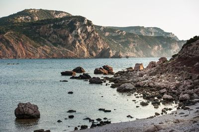 Rocks on sea shore against sky