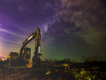 Built structure on field against sky at night