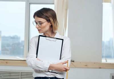 Portrait of young businesswoman using digital tablet in office
