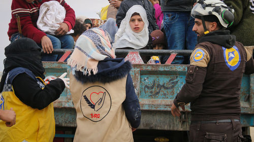 Group of people gathering outdoors in truck