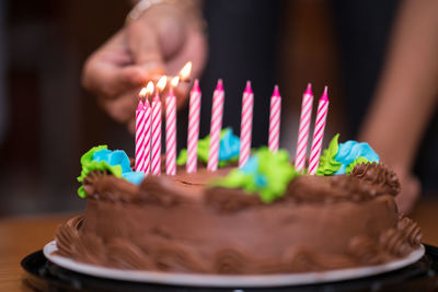 Close-up of hand holding chocolate cake