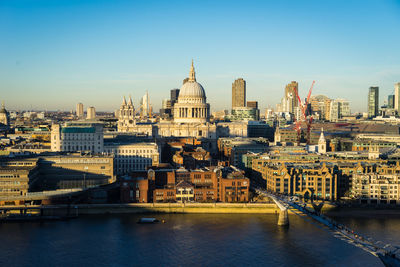 River amidst buildings against sky in city