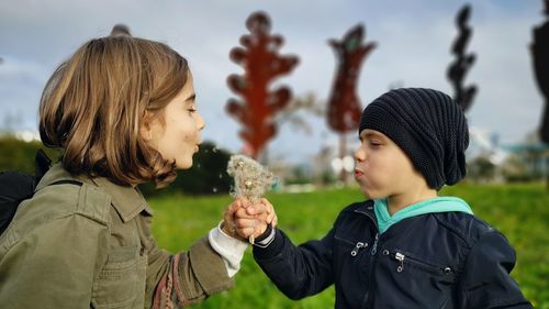 Portrait of children holding camera