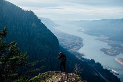 Woman standing on mountain road