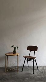 Empty chairs and table against wall at home