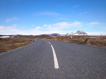 Empty road leading towards mountains