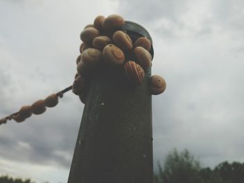 Low angle view of rope against cloudy sky