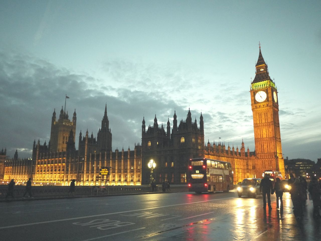 architecture, building exterior, built structure, city, transportation, illuminated, clock tower, car, sky, street, famous place, travel destinations, tower, land vehicle, capital cities, international landmark, travel, road, big ben, city life