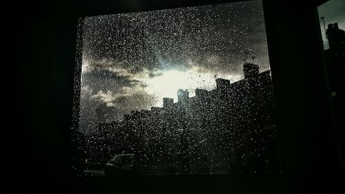 Raindrops on glass window at night