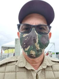 Portrait of man wearing sunglasses against sky