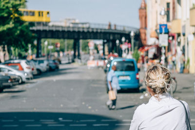 Rear view of woman standing on street