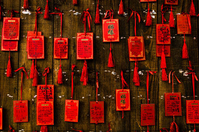 Close-up of red religious equipment hanging at temple