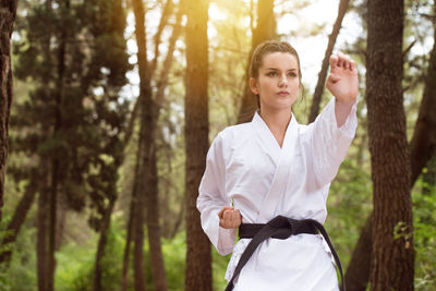 Young woman standing in forest