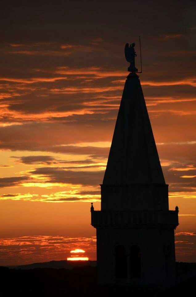 sunset, orange color, sky, architecture, built structure, building exterior, silhouette, cloud - sky, low angle view, religion, spirituality, place of worship, cloud, outdoors, sea, no people, nature, sun, beauty in nature