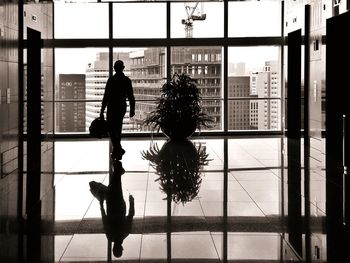 Woman standing in glass building