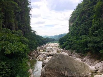 Scenic view of river against cloudy sky