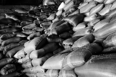 Full frame shot of sacks stacked in warehouse