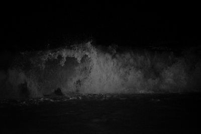 Full frame shot of rocks in water at night