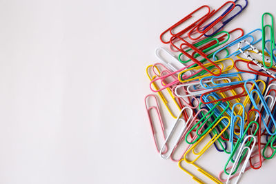 Close-up of colored pencils over white background