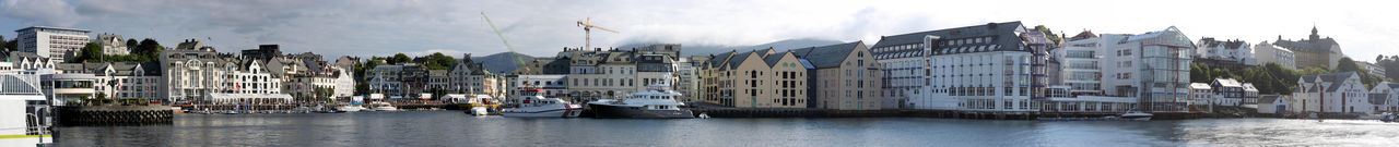 Panoramic view of town against cloudy sky