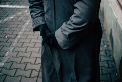 Low section of man standing on footpath