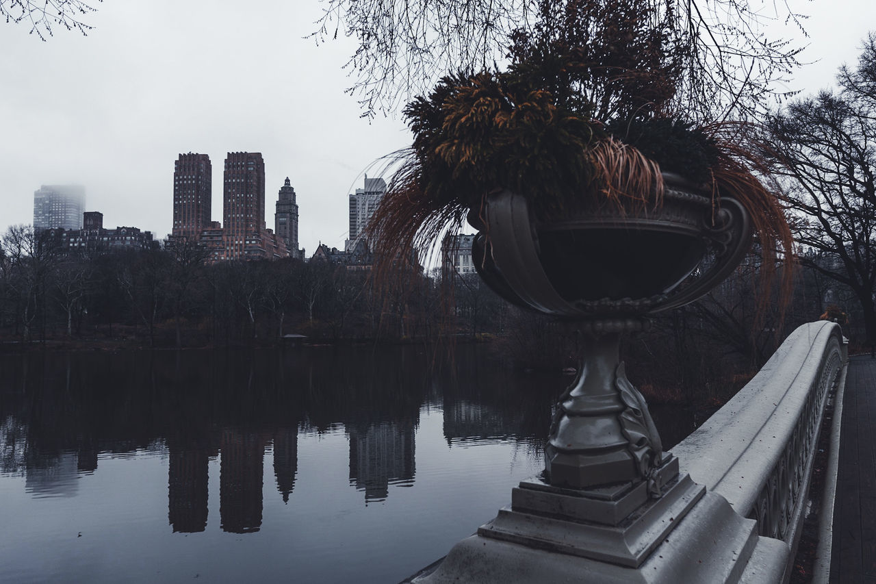 REFLECTION OF BUILDING IN LAKE AGAINST SKY