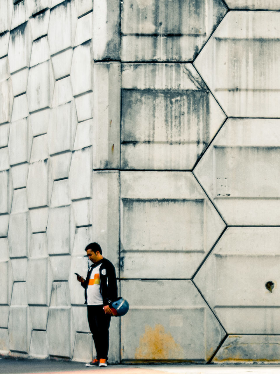 FULL LENGTH OF MAN WALKING BY BUILDING