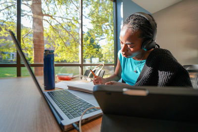 Young woman using laptop at home