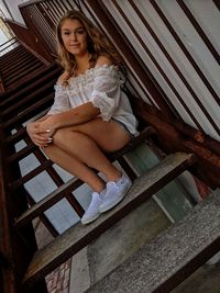 Woman sitting on staircase