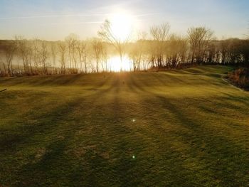 Scenic view of field against sky during sunset