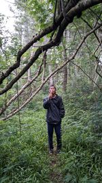 Full length of man standing in forest