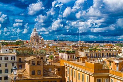 Cityscape against cloudy sky
