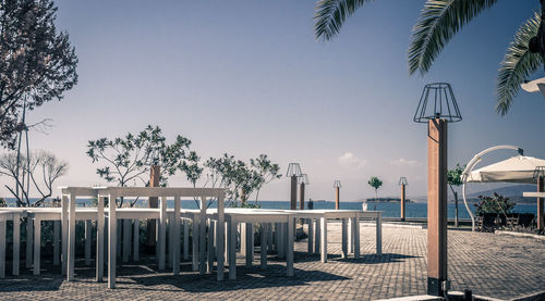 View of swimming pool by sea against clear sky