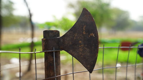 Traditional tomahawk hand axe used by the native american indians displayed on a iron fence outdoor.