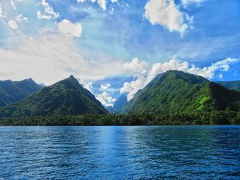 Scenic view of lake and mountains against sky