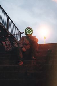 Low angle view of person on staircase against sky