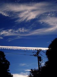 Low angle view of power lines against blue sky