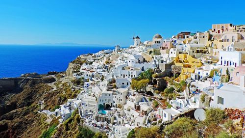 High angle view of town against blue sky