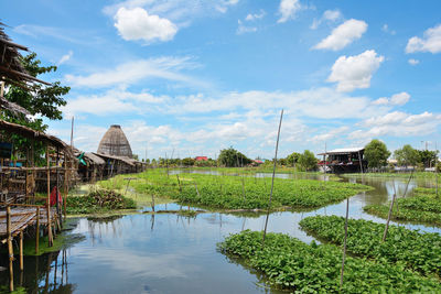 Thai market on the edge of the canal with sky as background